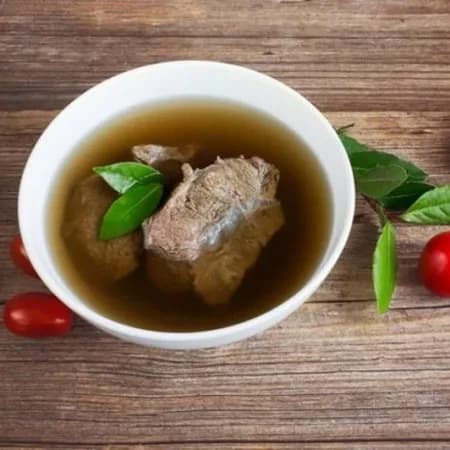 Pork in broth with herbs and herbs